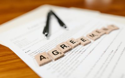 Is a commercial tenant liable for all rents owed under a lease agreement when they breach a settlement agreement calling for payment of a lesser amount?